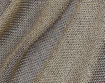 May include: Close-up of a gold metallic fabric with a fine mesh pattern.