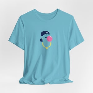 May include: A light blue t-shirt with a cartoon illustration of a person wearing a blue baseball cap and a gold chain, blowing a pink bubble.