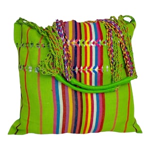 May include: A green woven tote bag with colorful stripes and a green handle. The bag has a fringe detail on the top.