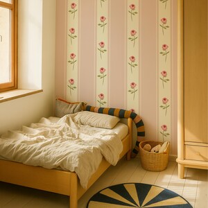 May include: A child's bedroom with a wooden bed, a round rug with blue and yellow stripes, and a woven basket. The walls are decorated with pink and cream striped wallpaper featuring pink rose illustrations.