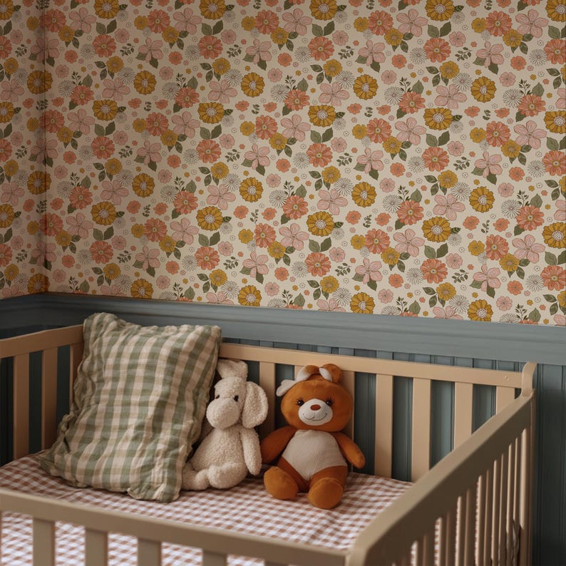 May include: A baby crib with a gingham patterned mattress and a green and white checkered pillow. A white stuffed dog and a brown teddy bear sit in the crib. The wall behind the crib is covered in floral wallpaper with pink, yellow, and orange flowers.