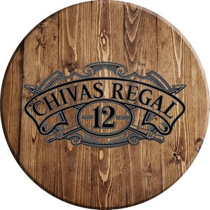 May include: A wooden round sign with a brown wood grain pattern. The sign features a gray and white logo with the text "Chivas Regal" and "Aged 12 Years".