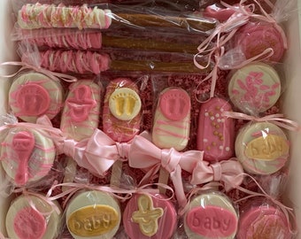 Beautiful Chocolate Dipped Pink, white, and gold baby shower treats, chocolate pops, chocolate Oreos, chocolate pretzels