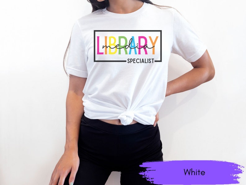 May include: White t-shirt with the text "LIBRARY MEDIA SPECIALIST" in a rainbow color scheme.