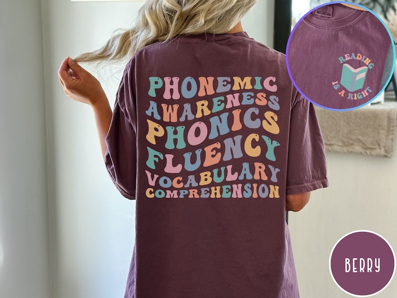 May include: A maroon t-shirt with the words "phonemic awareness, phonics, fluency, vocabulary, comprehension" in rainbow colors on the back. The front of the shirt has a small graphic of a book with the text "Reading is a right".