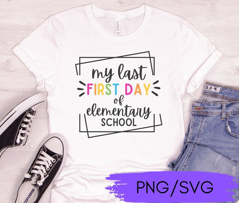 May include: White t-shirt with the text "my last FIRST DAY of elementary SCHOOL" in a colorful, rectangular frame. The text is in black with a rainbow-colored outline. The shirt is on a white surface with a pair of black sneakers and blue jeans.