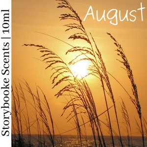 May include: A photograph of tall grass silhouetted against a sunset sky. The sun is setting behind the grass, casting a warm glow on the scene. The word "August" is written in white text at the top of the image.