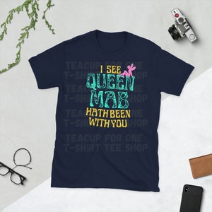 May include: Navy blue t-shirt with a teal green and yellow graphic that says "I see Queen Mab hath been with you". The graphic also includes a pink fairy.