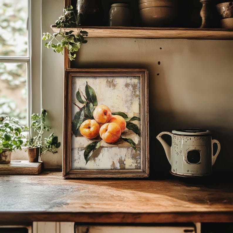 May include: A framed painting of a still life with four yellow peaches on a white background with green leaves.