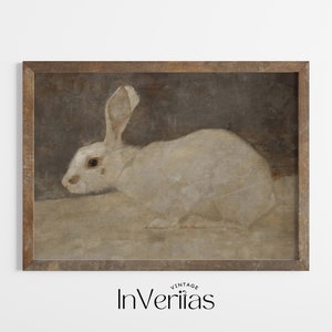 May include: A vintage framed print of a white rabbit with brown fur on its ears, against a brown background.