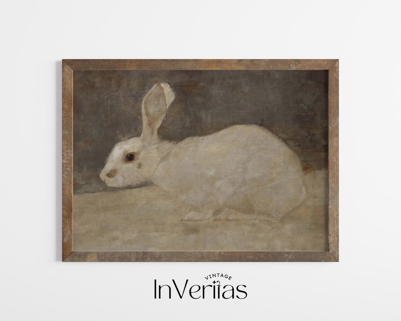 May include: A vintage framed print of a white rabbit with brown fur on its ears, against a brown background.