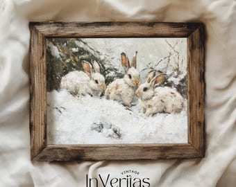 May include: A framed vintage print depicts three white rabbits in a snowy landscape. The artwork features a rustic wooden frame and a winter scene with the text "Vintage InVeriitas" at the bottom. The rabbits have brown ears and are surrounded by snow.