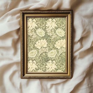 May include: A framed print of a vintage floral pattern featuring white flowers and green leaves on a dark green background.