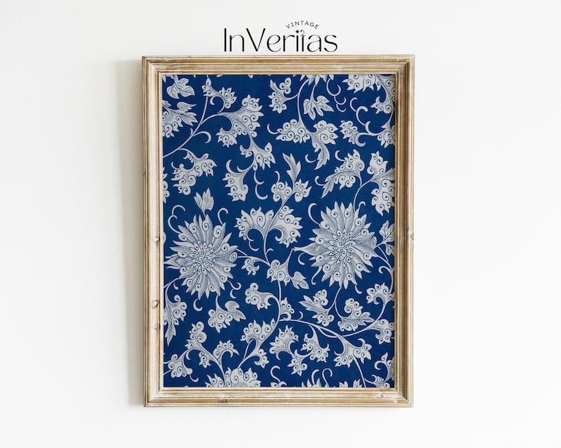 May include: A framed print featuring a blue background with a white floral design. The print is in a light wood frame.