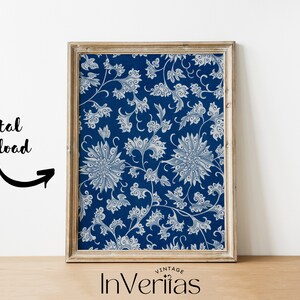 May include: A framed print of a vintage blue and white floral pattern. The pattern features stylised flowers and leaves. The frame is a light wood colour.