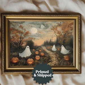 May include: A framed painting of a spooky forest scene with three white ghosts and jack-o-lanterns. The painting is in a gold frame with a dark brown mat.