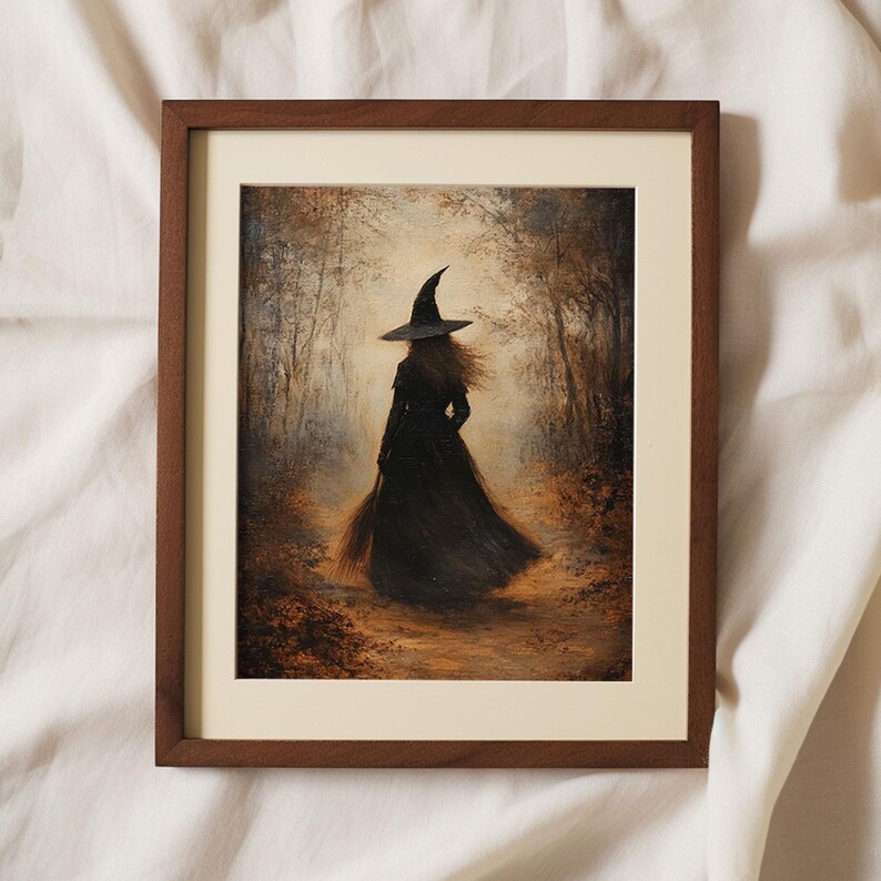 May include: A framed painting of a witch walking through a forest. The witch is wearing a black dress and a pointed hat. The forest is filled with trees and leaves in shades of brown and gold.