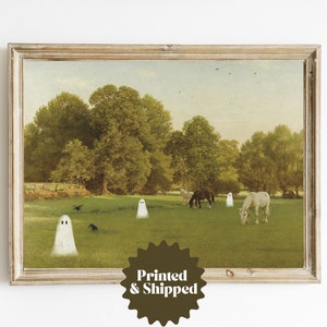 May include: A framed print featuring a pastoral scene with horses grazing in a green field. Several cartoon ghosts are scattered throughout the landscape. The print is in a rustic wooden frame. The text "Printed & Shipped" is on the bottom right.
