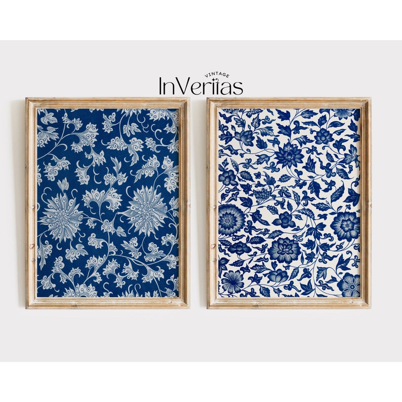 May include: Two framed prints featuring blue and white floral patterns. The prints are in wooden frames with a light wood finish.