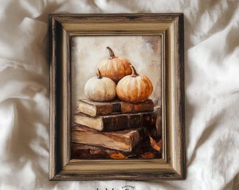 May include: A framed painting featuring three pumpkins atop a stack of books. The pumpkins are orange and white, and the books are brown. The painting has a vintage aesthetic, with the text "InVeritas" at the bottom.
