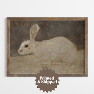 May include: A vintage-style painting of a white rabbit in a brown frame. The rabbit is depicted in a realistic style with soft, muted colors.