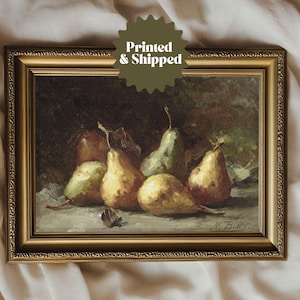 May include: A framed oil painting depicting a still life of five pears in various shades of green and brown. The pears are arranged on a table with a dark background. The painting is signed "H. Bella" in the bottom right corner.