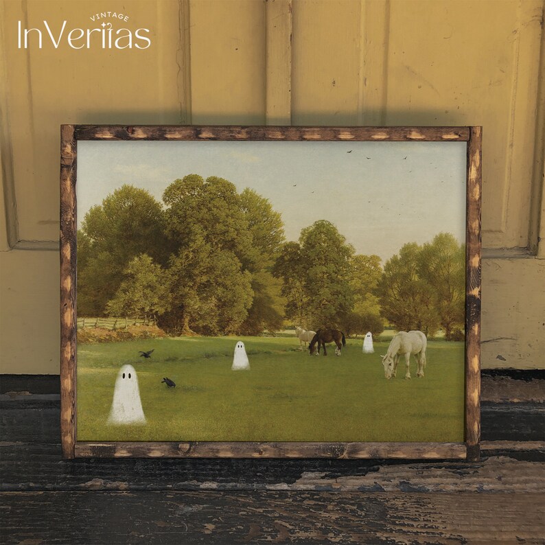 May include: A framed vintage print featuring a pastoral scene with horses grazing in a field. White ghost figures are scattered across the green grass. The print is set in a dark brown wooden frame, with the text "InVeritas Vintage" in the upper left corner.