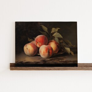 May include: A still life painting of a bowl of peaches with green leaves. The peaches are a mix of red and yellow, and the bowl is a dark brown color.