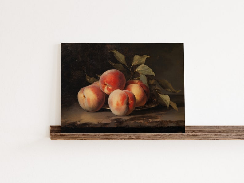 May include: A still life painting of a bowl of peaches with green leaves. The peaches are a mix of red and yellow, and the bowl is a dark brown color.