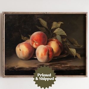 May include: A framed painting of a still life featuring five peaches on a plate with green leaves. The peaches are a mix of red and yellow tones, and the background is a dark brown.