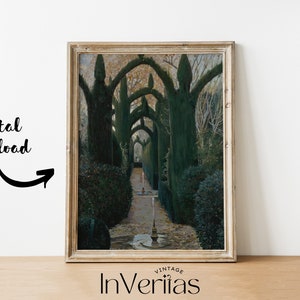 May include: A framed print of a vintage photograph showing a pathway lined with trees that have been pruned into arches. The trees are green and the pathway is lined with stones. The image is in a light wood frame.