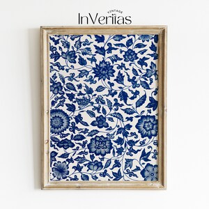 May include: A framed print featuring a blue and white floral pattern. The print has a repeating design of stylised flowers and leaves.