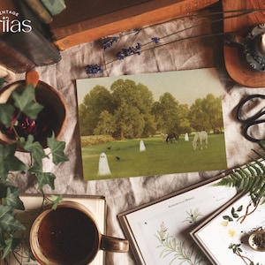 May include: A vintage postcard featuring a pastoral scene with horses grazing in a field, and several cartoon ghosts. The image is surrounded by books, a cup of coffee, a lit candle, and other decorative items. The word "Vintage" is at the top.