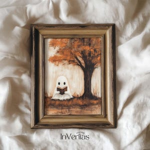 May include: A framed painting featuring a white ghost reading a book under a tree with orange leaves. The artwork has a vintage style and is set against a light background. The text "Vintage InVeriitas" is at the bottom.