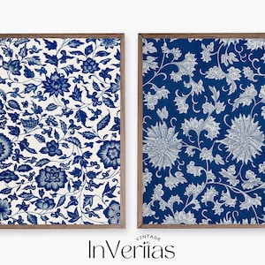 May include: Two framed prints featuring blue and white floral patterns. The print on the left has a white background with blue flowers. The print on the right has a blue background with white flowers.