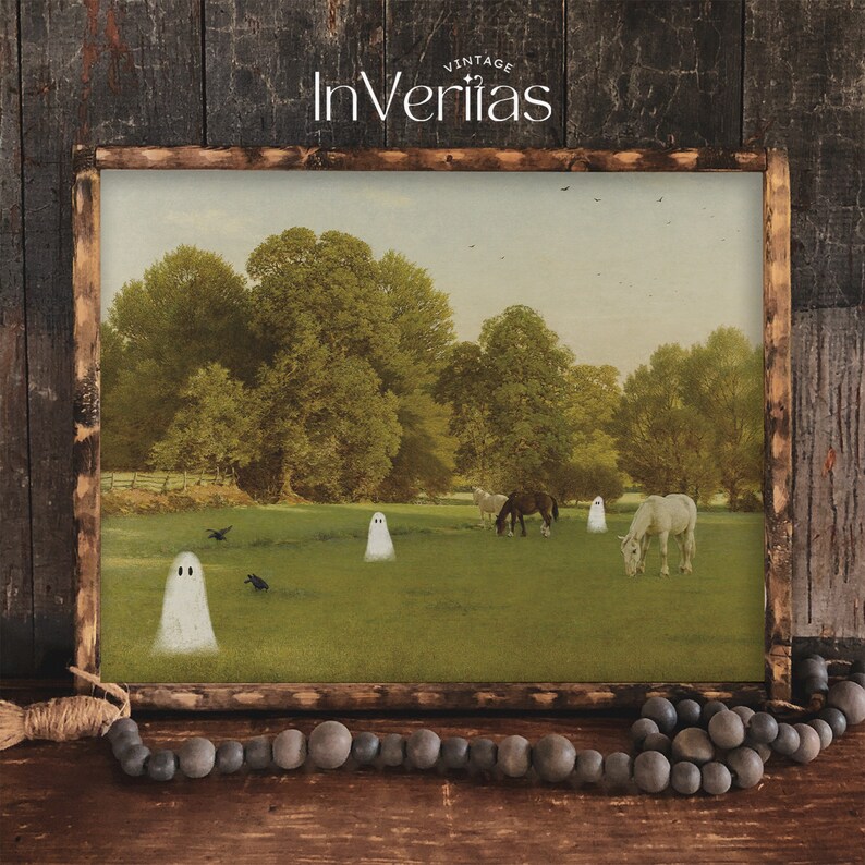 May include: A framed print featuring a pastoral scene with horses grazing in a field, with cartoon ghosts and crows. The print has a rustic wooden frame and the text "Vintage InVeritas" at the top.