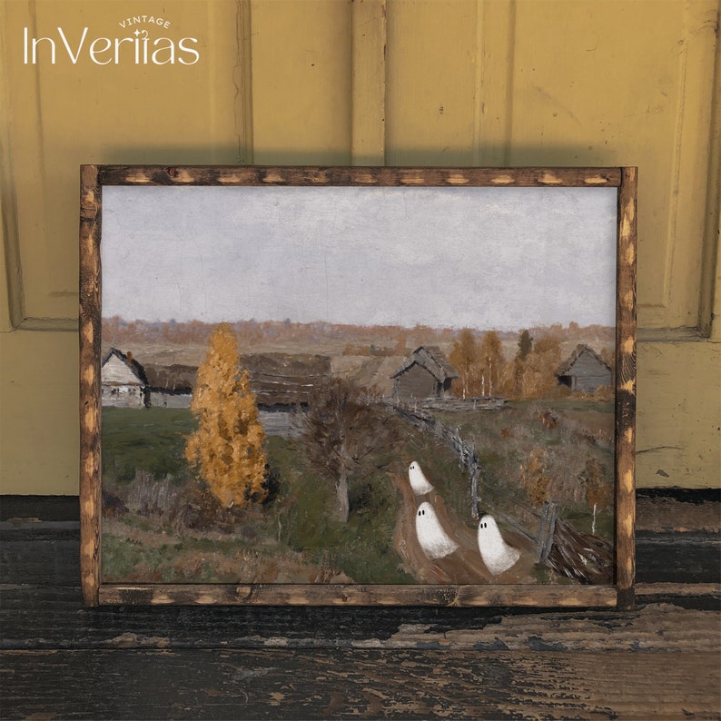 May include: A framed painting of a rural landscape with three white ghosts walking down a path. The painting is set in a fall scene with trees with yellow leaves. The painting is framed in a dark wood frame.