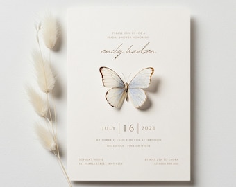 May include: A cream-colored bridal shower invitation card featuring a central butterfly illustration with light blue and white wings. The text reads: Please join us for a bridal shower honoring Emily Hudson, July 16, 2026, at three o'clock in the afternoon.