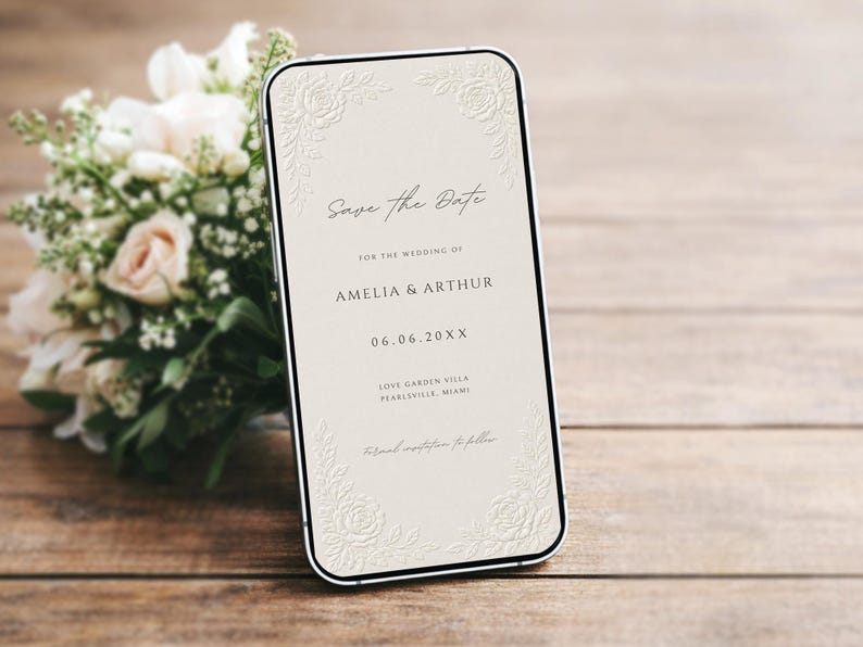 Puede incluir: Un tel&eacute;fono inteligente que muestra un anuncio digital de Save the Date para la boda de Amelia y Arthur el 06.06.20XX, en Love Garden Villa en Pearlsville, Miami. La pantalla tiene un fondo crema con dise&ntilde;os florales en relieve.