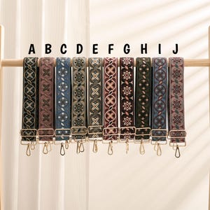 May include: Nine different patterned straps with gold hardware. The straps are labeled A through J.
