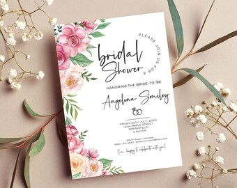 May include: A white bridal shower invitation with floral accents. The invitation features pink and peach watercolor flowers and green leaves. Text includes "Bridal Shower", the bride's name, and event details. The invitation is surrounded by sprigs of white flowers and greenery.