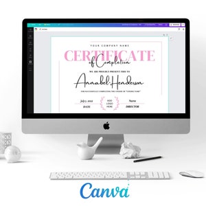 May include: A computer screen displays a certificate of completion template. The certificate features pink and black text, including "Certificate of Completion" and the name "Annabel Henderson." The Canva logo is visible at the bottom.