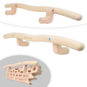 May include: A light-coloured wooden climbing hangboard featuring a curved pull-up bar with the text GRIPNATIC printed on the front. The device includes multiple recessed grip pockets and holds for finger training, with visible metal mounting screws.