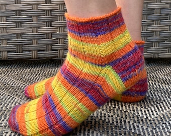 May include: Striped ankle socks in shades of orange, yellow, red, and purple.