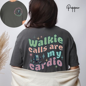 May include: A dark gray t-shirt with the text "Walkie calls are my cardio" in colorful letters. A cartoon walkie-talkie is running next to the text.