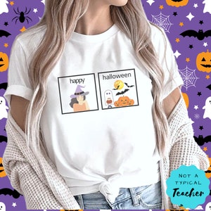 May include: White t-shirt featuring a graphic of two squares. The left square reads "happy" and depicts a cartoon witch. The right square reads "halloween" and shows a cartoon ghost and pumpkins. The text "NOT A TYPICAL TEACHER" is in the bottom right corner of the shirt.