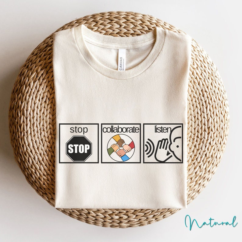 May include: A white t-shirt with a graphic design featuring three squares. The first square says "stop" with a red stop sign inside. The second square says "collaborate" with a graphic of hands of different skin tones holding each other. The third square says "listen" with a graphic of a hand over an ear.
