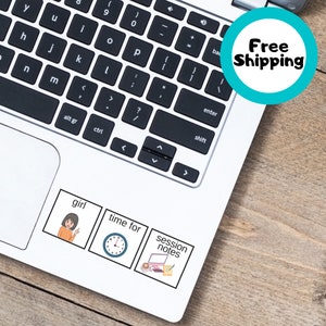 May include: A white laptop computer with three stickers on the bottom right corner. The stickers are square and have black outlines. The first sticker shows a cartoon girl pointing to herself with the word "girl" above her. The second sticker shows a clock with the words "time for" above it. The third sticker shows a laptop computer with a notepad and a cup of coffee with the words "session notes" above it.