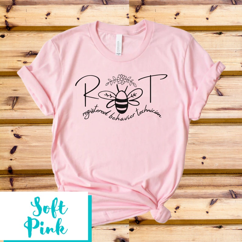 May include: A pink t-shirt with a black graphic of a bee with the text "RBT registered behavior technician" on it.