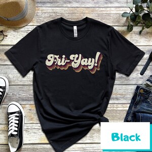 May include: Black t-shirt with a retro-style graphic that says "Fri-Yay!" in colourful letters.